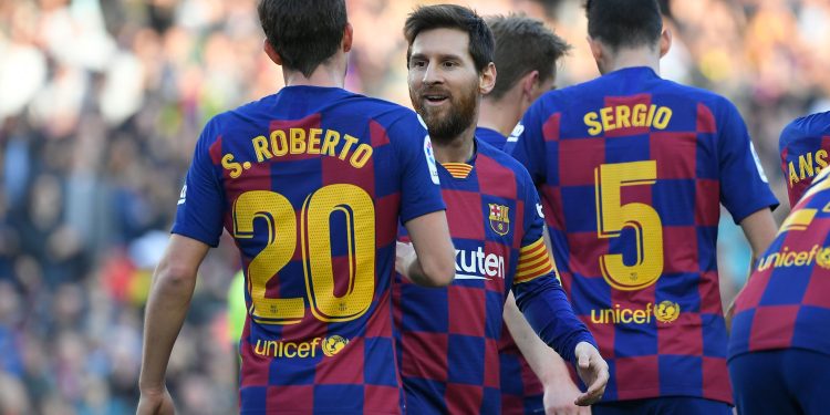 Barcelona's Spanish defender Sergi Roberto (L) celebrates with Barcelona's Argentine forward Lionel Messi  after scoring during the Spanish league football match between FC Barcelona and Getafe CF at the Camp Nou stadium in Barcelona on February 15, 2020. (Photo by LLUIS GENE / AFP) (Photo by LLUIS GENE/AFP via Getty Images)